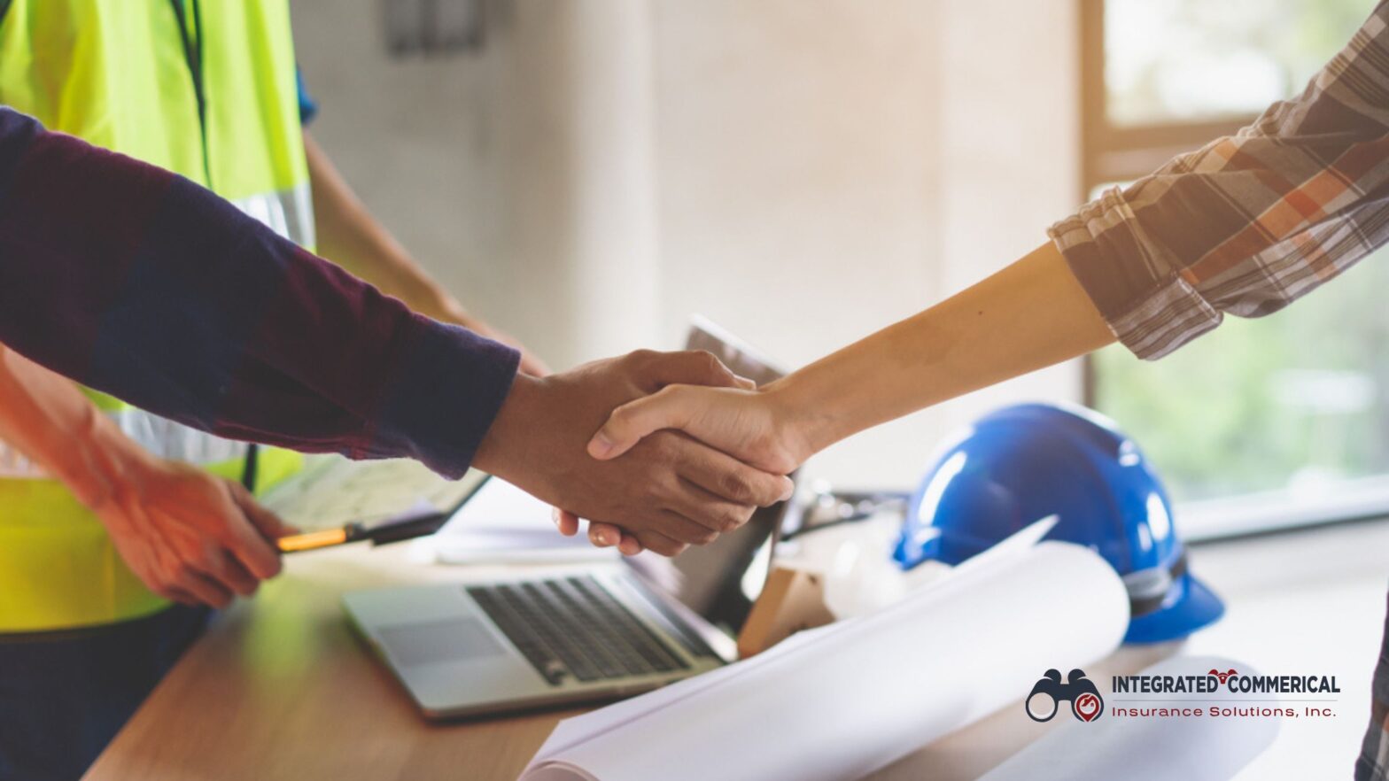 Handshake between contractors and insurance agent